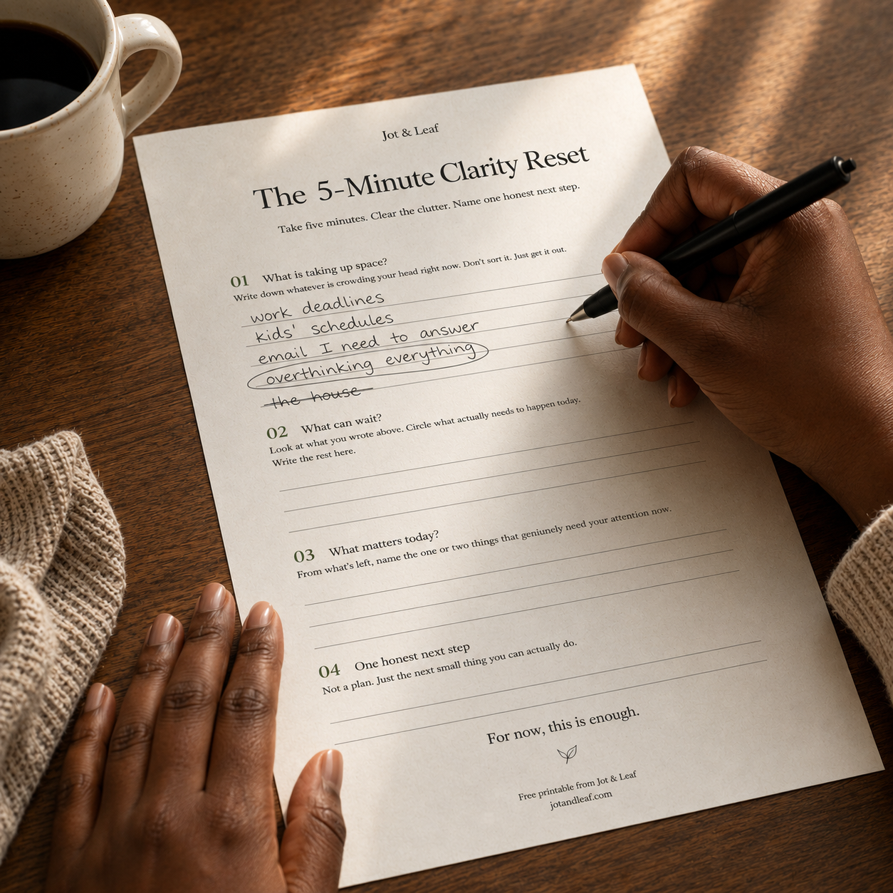 A hand writing on the Jot and Leaf 5-Minute Clarity Reset worksheet